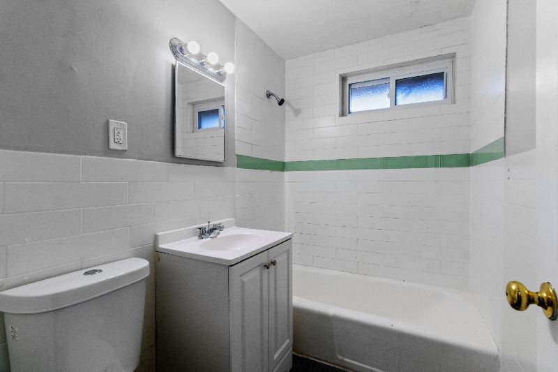 Tiled bathroom with tub and shower