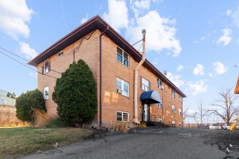 Front of 45 Elam Street with evergreen trees
